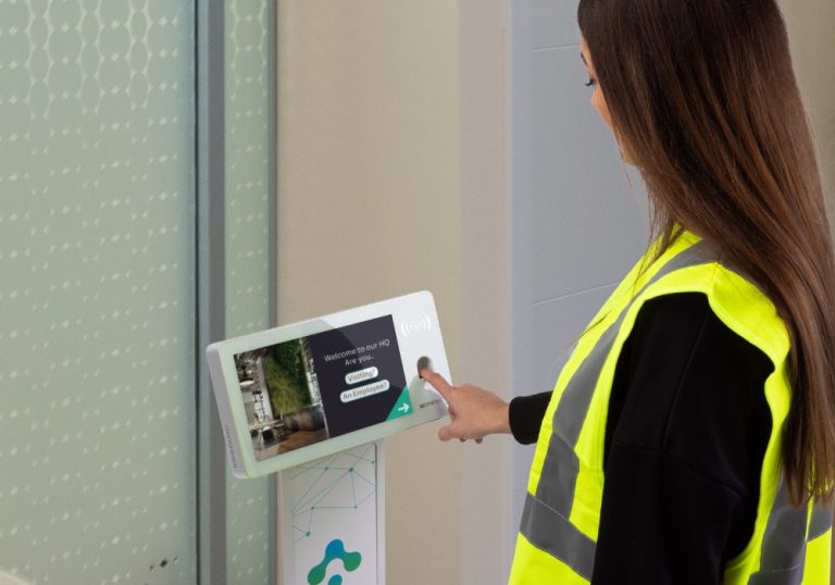 a woman wearing a safety vest using a touch screen device