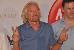 two men standing in front of a sign