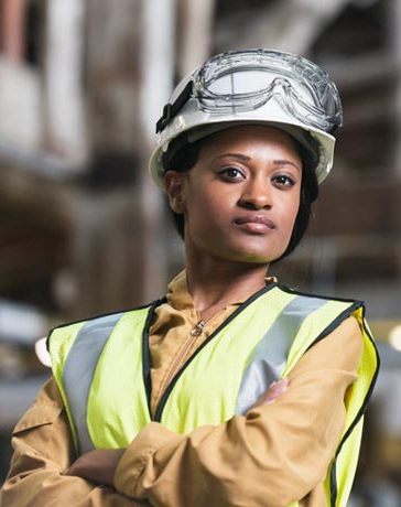 a woman wearing a safety vest and a hard hat